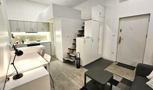 a small white apartment with a kitchen and a living room at Studio Gea in Semedela