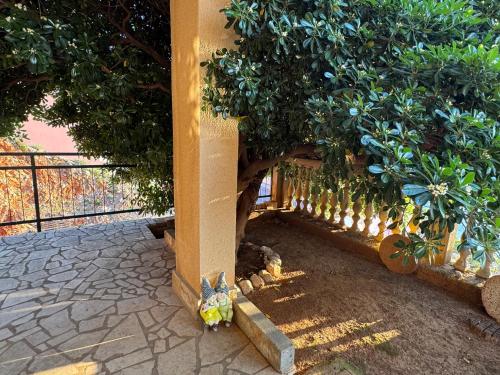 a bird standing next to a wall with trees at Apartment GOLDENS with a sea view in Senj