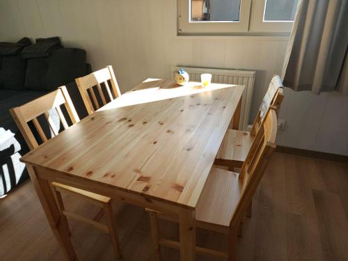 a wooden table and chairs in a living room at Domek 2 Wdechy in Wdzydze Kiszewskie