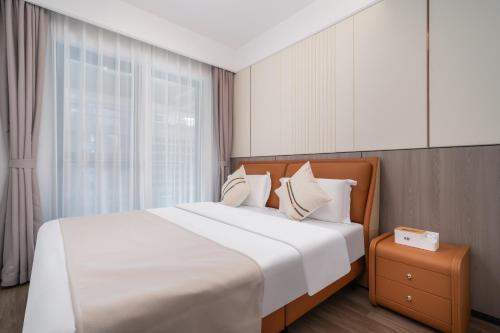 Postel nebo postele na pokoji v ubytování Liangting Boyue Center Serviced Apartment