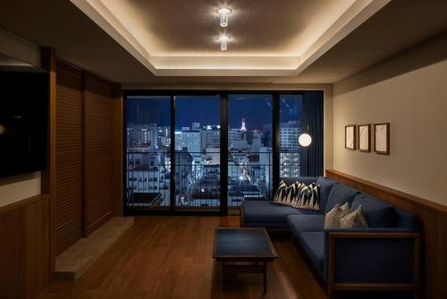 a living room with a couch and a large window at Southwest Grand Hotel in Naha