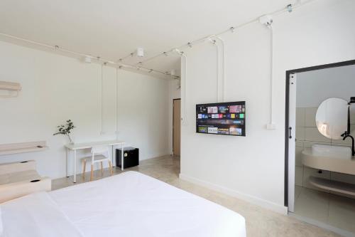 a white room with a sink and a mirror at Lfour phuket in Phuket Town