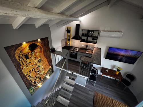 an overhead view of a room with a staircase and a living room at Klimt & Van Gogh Vista Lago by Abitare Il Tempo in Nemi
