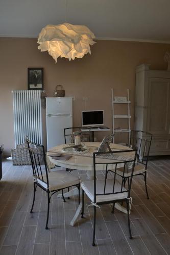 a dining room with a table and chairs and a kitchen at Il Sentiero Del Cuore B&B in Ravenna