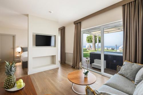 a living room with a couch and a tv at Aldiana Club Rocca Nettuno Calabria in Tropea