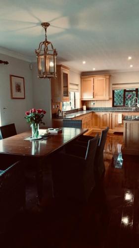 a kitchen with a table with a vase of flowers on it at Traditional English house TravellerAwards2026 in Brighton & Hove