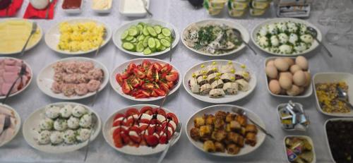 a table topped with bowls of different types of food at Hotel Dworek in Wrocław