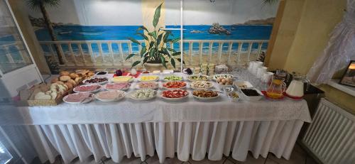 a table with many plates of food on it at Hotel Dworek in Wrocław