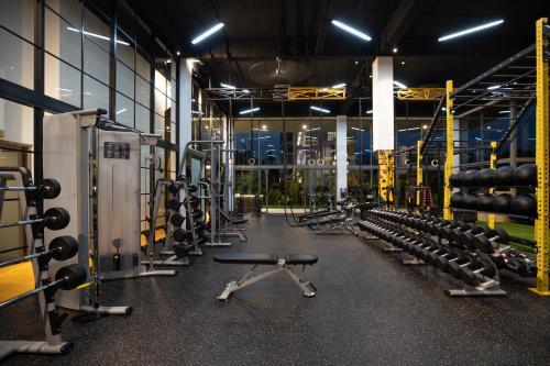 a gym with rows of equipment in a building at Elite Atoll Serviced Apartments Phuket in Rawai Beach