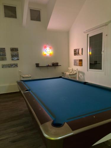 a billiard room with a pool table in it at Prairie in Al Khaznah