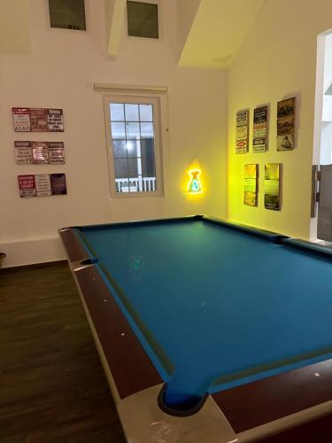 a billiard room with a pool table in it at Prairie in Al Khaznah