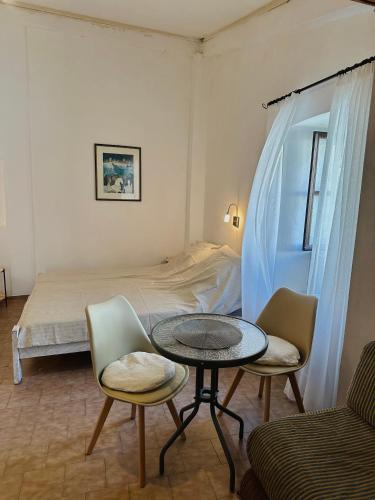 a room with a bed and a table and chairs at Stone house Becici in Budva