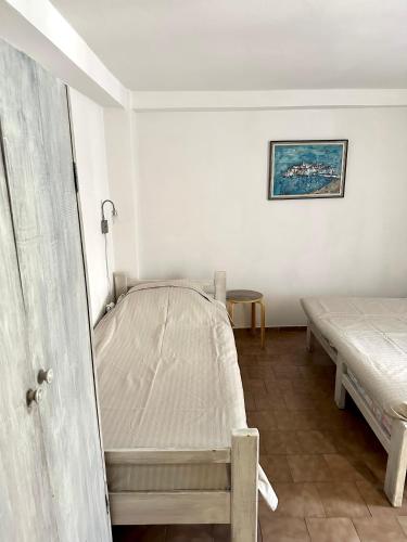 a bedroom with two beds in a room at Stone house Becici in Budva