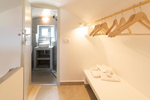 a bathroom with a white counter and a sink at Dauti Gold Suites in Vóthon