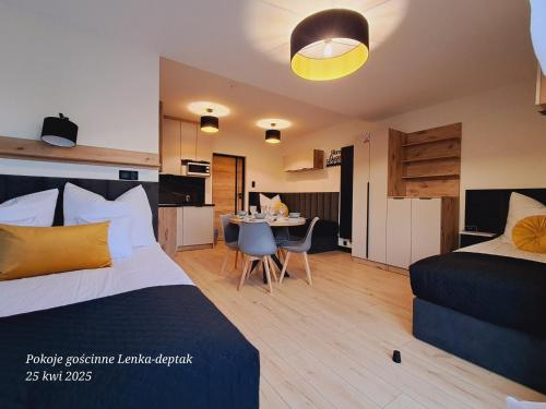 a hotel room with a bed and a dining room at Pokoje gościnne Lenka-deptak in Ciechocinek