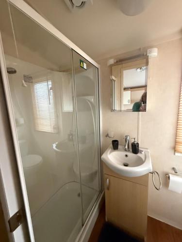 a bathroom with a shower and a sink at Serenity 1 and Serenity 2 Central lounge 3 bedrooms sleep 6 with 2 bathrooms in Lowestoft
