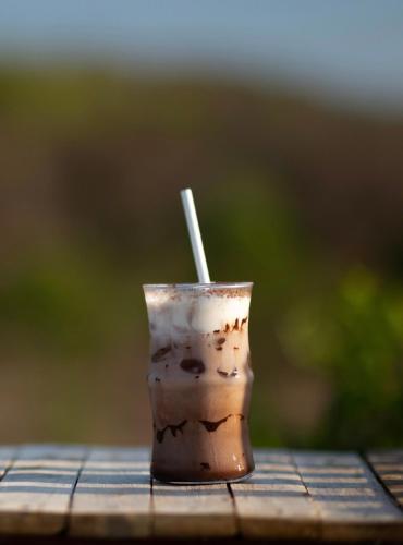 a drink with a straw sitting on a table at Chuồn Chuồn Retreat in Phan Thiet