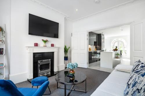 a living room with a couch and a fireplace at Stylish 2BR APT with Garden by St Pancras International in London