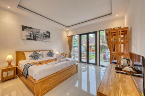 a bedroom with a bed and a large window at Nusa Dewata Cottage in Nusa Penida