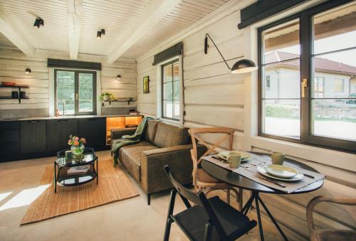 a living room with a couch and a table at Kalnziedi in Sigulda