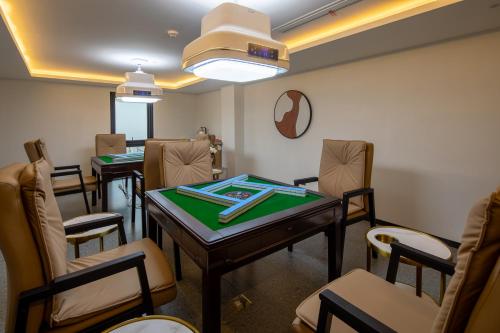 een wachtkamer met een tafel en stoelen bij Xinchi Sakura Valley Resort in Shaoxing