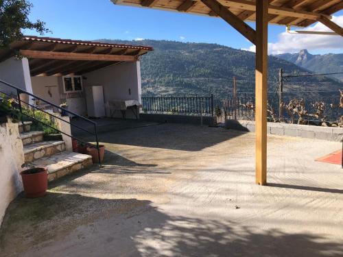 a porch of a house with a view of a mountain at Helmos View - Relaxation & Nature in Valimí