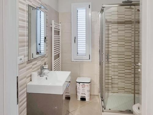 a white bathroom with a sink and a shower at Casa La Pace in Barga