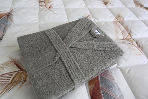 a hat and ties sitting on a bed at Joelisrentapartments monolocale e bilocale in Vlorë