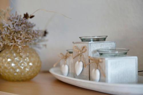 a group of candles on a table with a vase at Gästehaus Tadenswarf in Tadenswarf