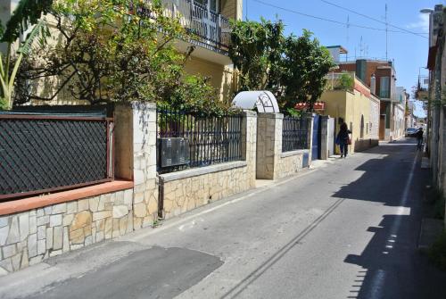an empty street with a fence on the side of a building at B&B La Villetta Palese in Bari