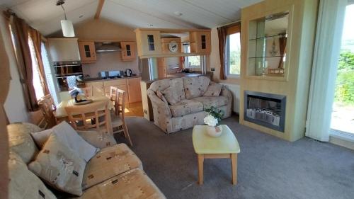 a living room with a couch and a fireplace at Seaside chalet in Ardmore with breathtaking views in Ardmore