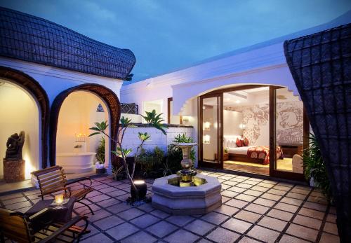 a patio with a fountain and a bed in a room at Taj Bekal Resort & Spa, Kerala in Bekal