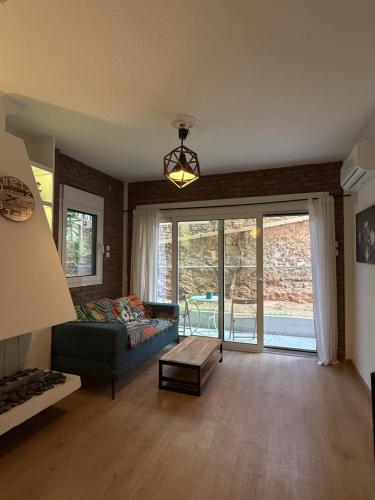 a living room with a couch and a large window at Luxury suites XiangBaLa Glyfada in Athens
