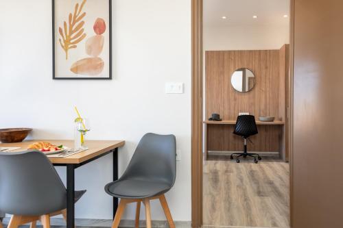 a kitchen with a table and two chairs and a desk at Anele Luxury Suites - Roof Top Jacuzzi in Chania Town