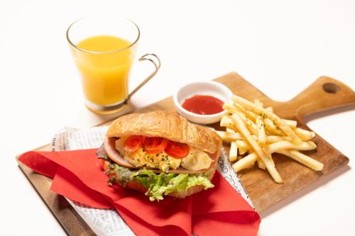 a sandwich and french fries and a glass of orange juice at Hotel LOVE JEWEL in Kitakyushu