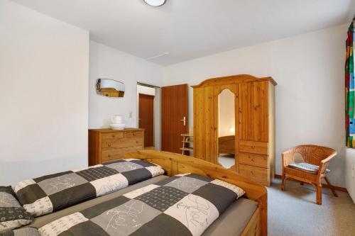 a bedroom with two beds and a dresser at Ferienwohnung Bunsoh in Bunsoh