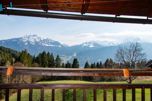 a view of the mountains from a wooden bench at Urlaub wie früher bei Oma in Hermagor