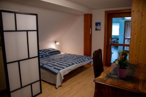 a bedroom with a bed and a mirror at Urlaub wie früher bei Oma in Hermagor