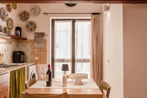 a kitchen with a table with a bottle of wine at Cantina Rustica in Montallegro