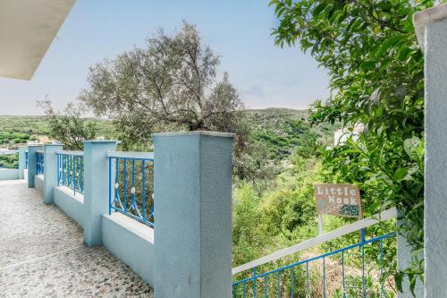 a view from the balcony of a house with a blue fence at Stenies Little Nook in Steniaí