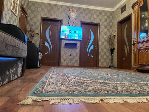 a living room with a door and a rug at Gabala Home in Gabala