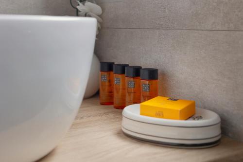 a group of bottles of orange liquid sitting next to a toilet at Hotel Ribadesella Playa in Ribadesella