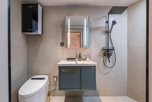 a bathroom with a toilet and a sink and a shower at Peking Courtyard Qianmen in Beijing