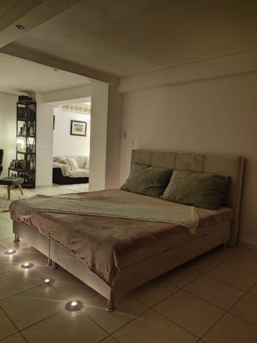 a bedroom with a large bed with lights on it at Basement Suite in Tríkala