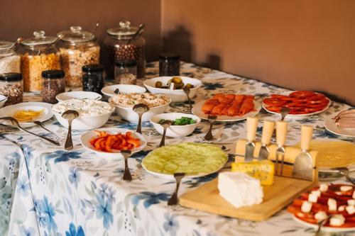 a table topped with plates of food and appetizers at Villa Pepita in Miedzygorze