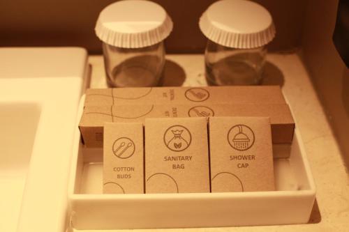 two boxes and two glasses in a drawer at Citadines Connect Airport Jakarta in Tangerang