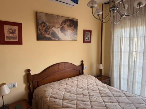 a bedroom with a bed and a painting on the wall at Apartamento Torrox5 in Torrox Costa