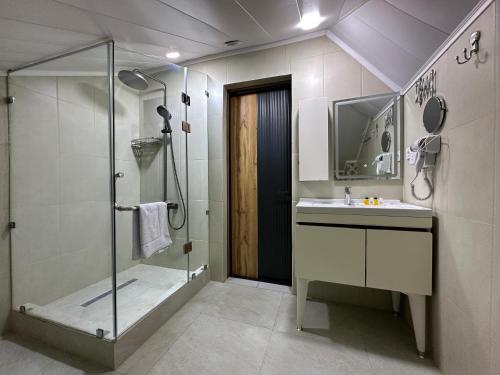 a bathroom with a shower and a sink at Safia Guest House in Andijan