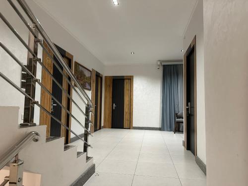 a hallway with a staircase in a house at Safia Guest House in Andijan