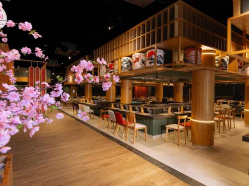 a restaurant with tables and chairs and pink flowers at Grand Sirenis Riviera Maya Resort & Spa All Inclusive in Akumal